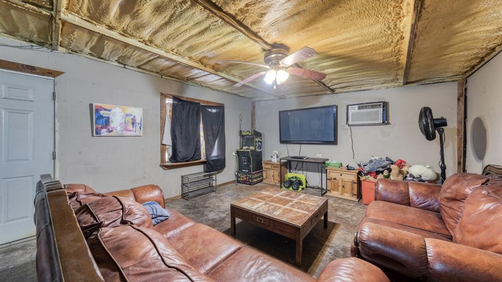 1700 Bennett Road Millsap, TX 76066 - Photo 26 of 40 a living room with furniture and a flat screen tv