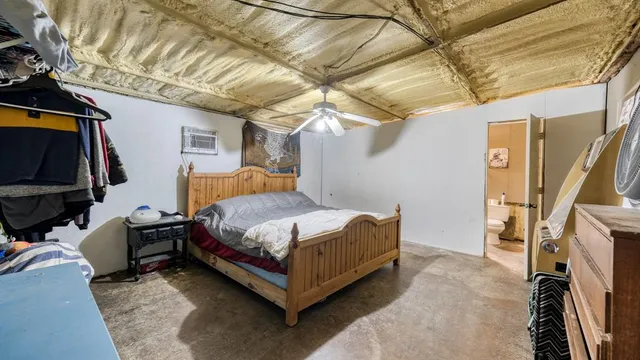 a bedroom with a bed and a walk in closet