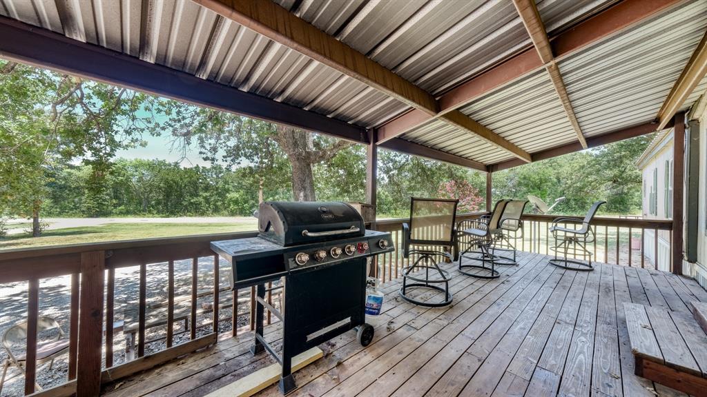 1700 Bennett Road Millsap, TX 76066 - Photo 4 of 40 a view of a balcony with chairs and wooden floor
