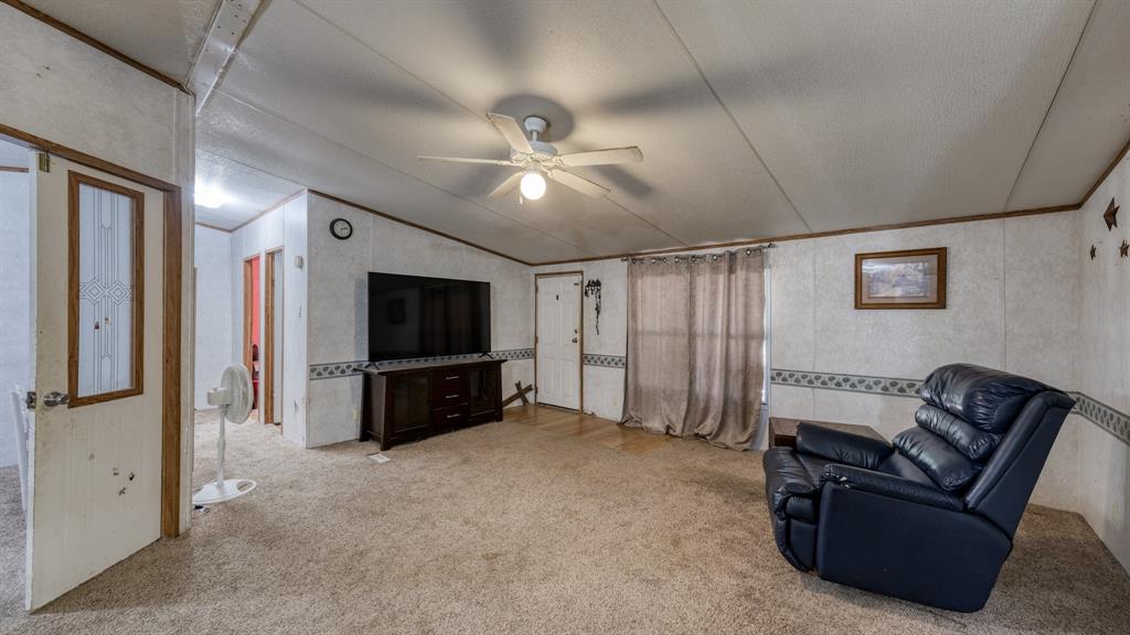 1700 Bennett Road Millsap, TX 76066 - Photo 6 of 40 a living room with furniture and a flat screen tv