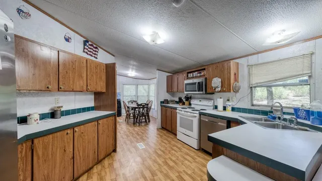 a kitchen with lots of counter top space and stainless steel appliances