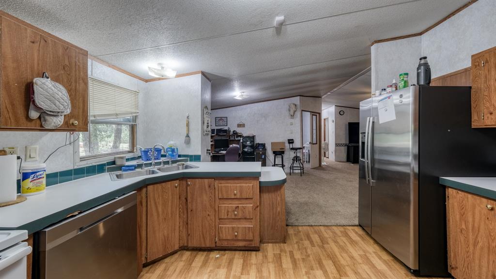 1700 Bennett Road Millsap, TX 76066 - Photo 9 of 40 a kitchen with stainless steel appliances granite countertop a refrigerator and a sink