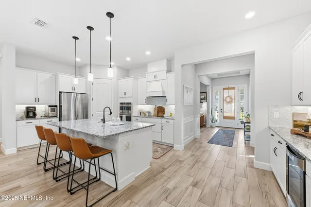 a large kitchen with granite countertop lots of counter space and a sink