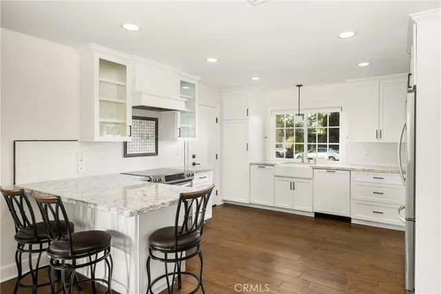 a kitchen with a table chairs stove and cabinets