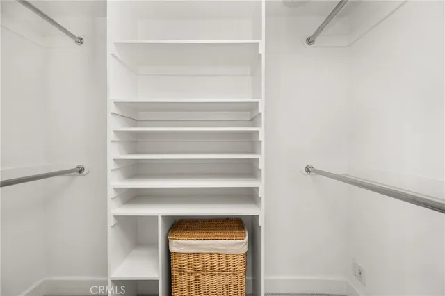 a view of walk in closet with empty racks