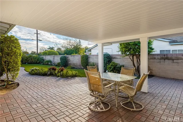 a view of a patio with table and chairs potted plants with wooden floor