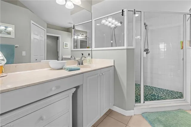 a bathroom with a double vanity sink mirror and shower