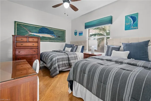 a bedroom with two beds and a dresser