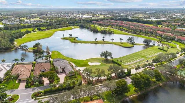 an aerial view of residential houses with outdoor space and river