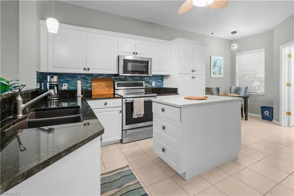 a kitchen with stainless steel appliances a sink stove and cabinets