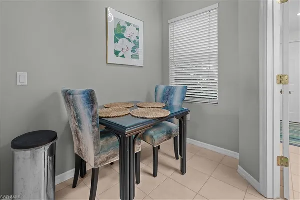 a view of a dining room with furniture and a window