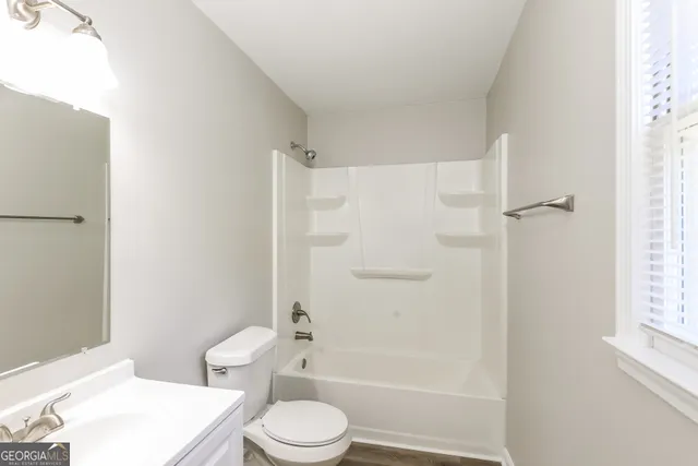 a bathroom with a toilet a sink and shower