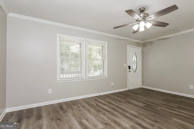 wooden floor in an empty room with a window