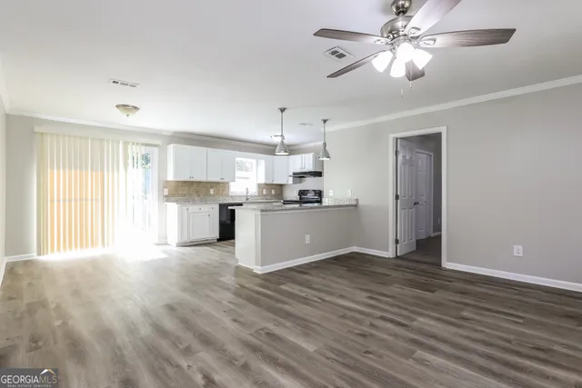 a view of a kitchen with a dishwasher cabinets and wooden floor