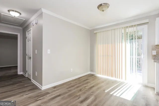a view of a livingroom with wooden floor and a window