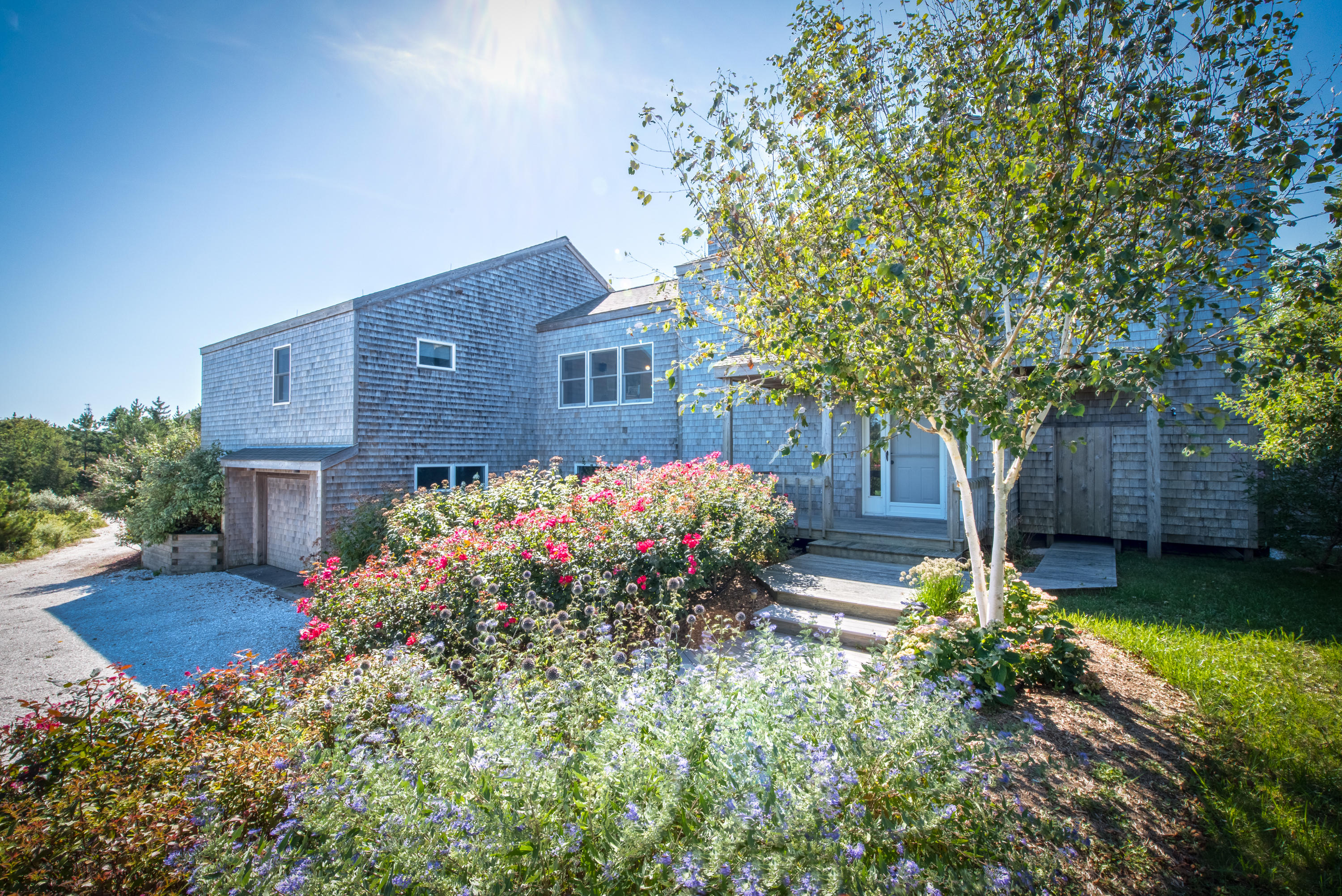 a front view of a house with a yard and fountain