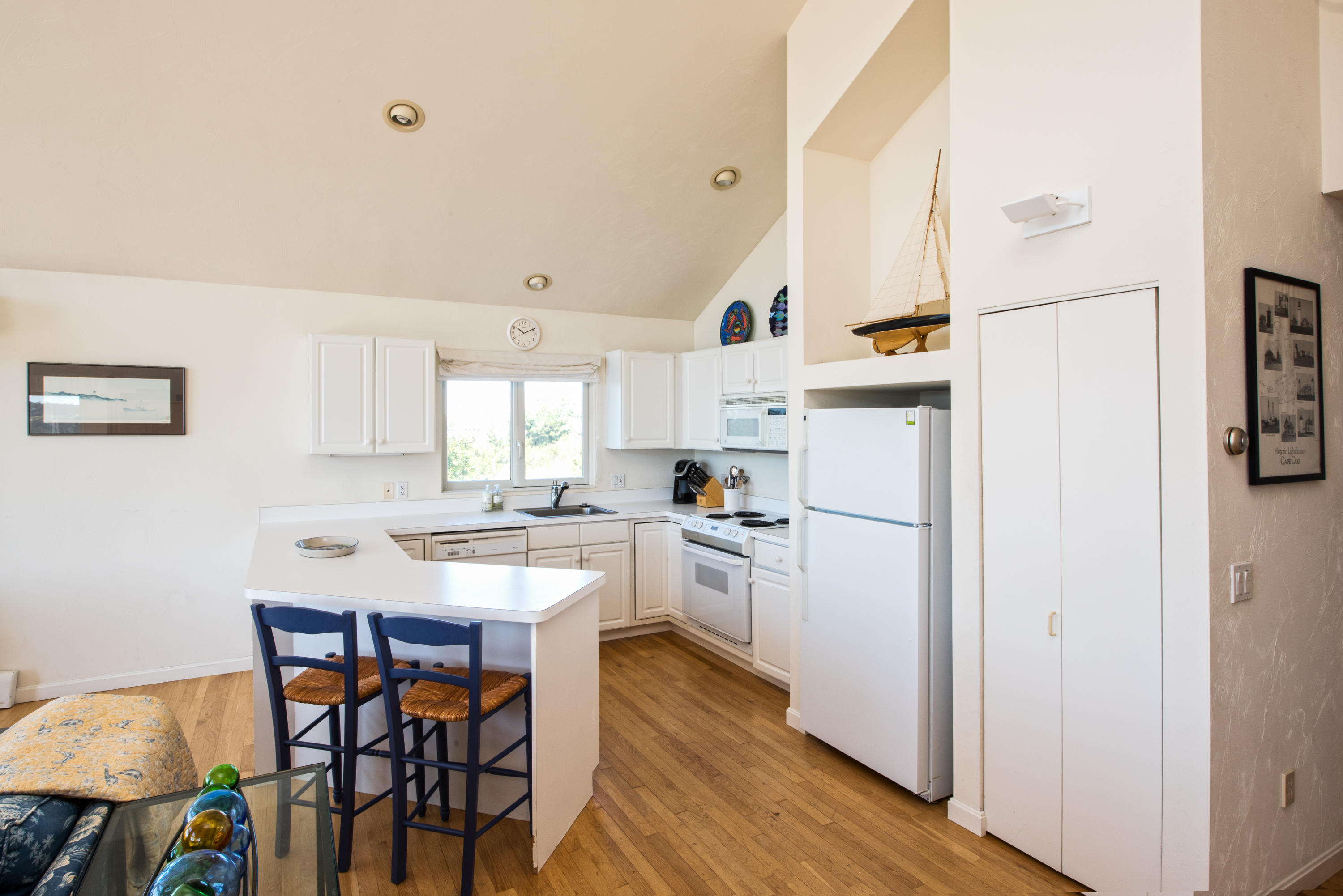 13 Avocet Road Truro, MA 02666 - Photo 14 of 35 a kitchen with a sink a stove a refrigerator and white cabinets