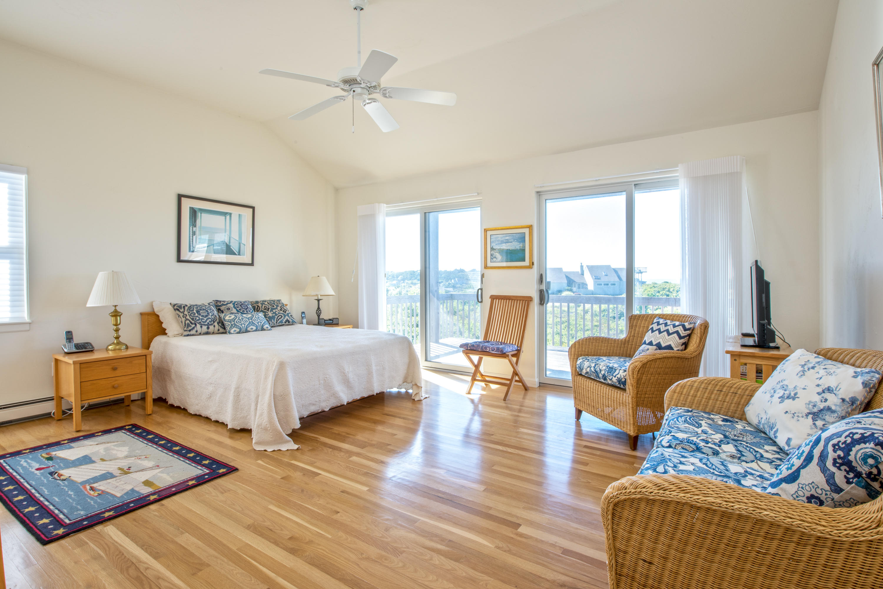 13 Avocet Road Truro, MA 02666 - Photo 16 of 35 a spacious bedroom with a large bed and a couch