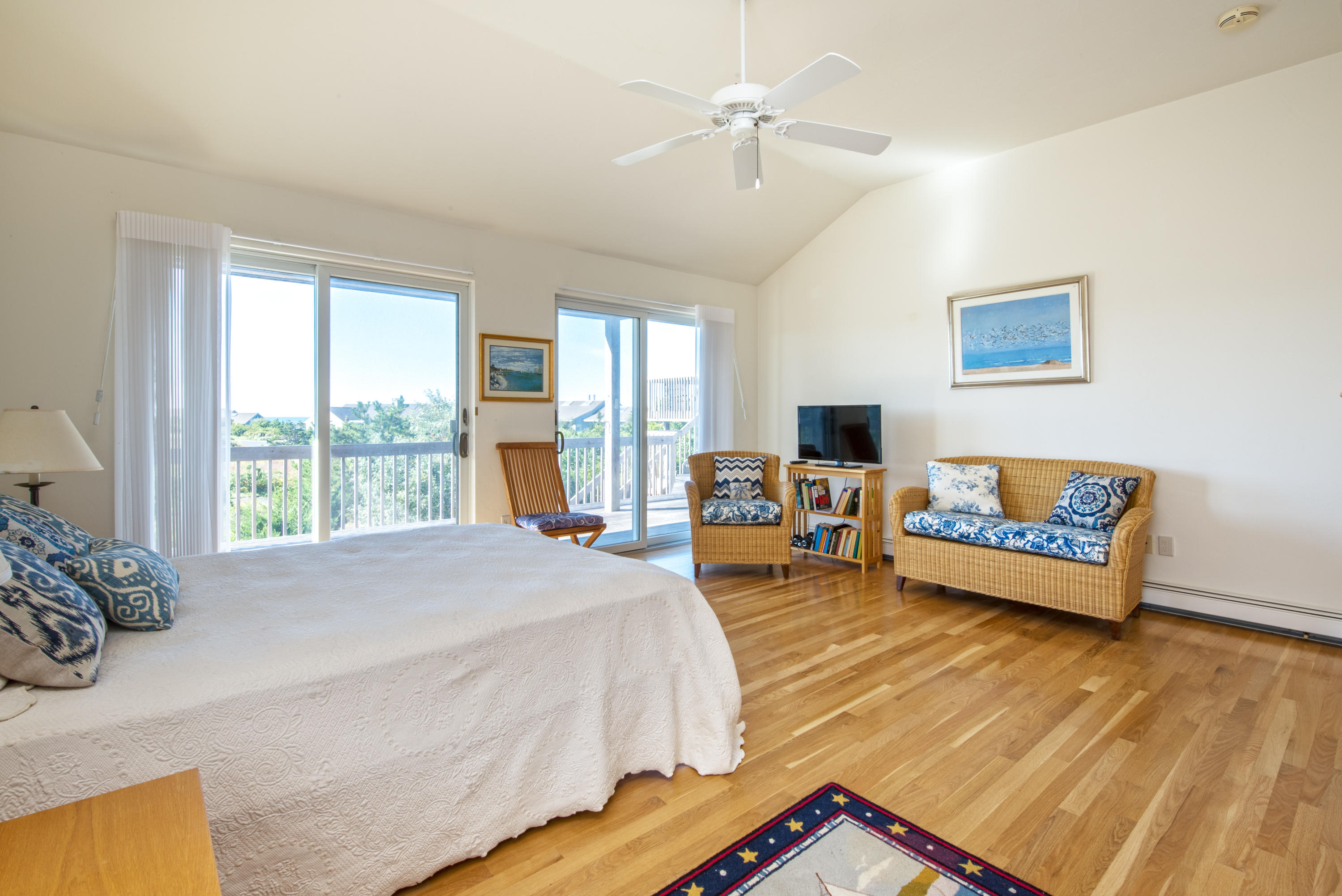13 Avocet Road Truro, MA 02666 - Photo 17 of 35 a spacious bedroom with a bed a couch and large window