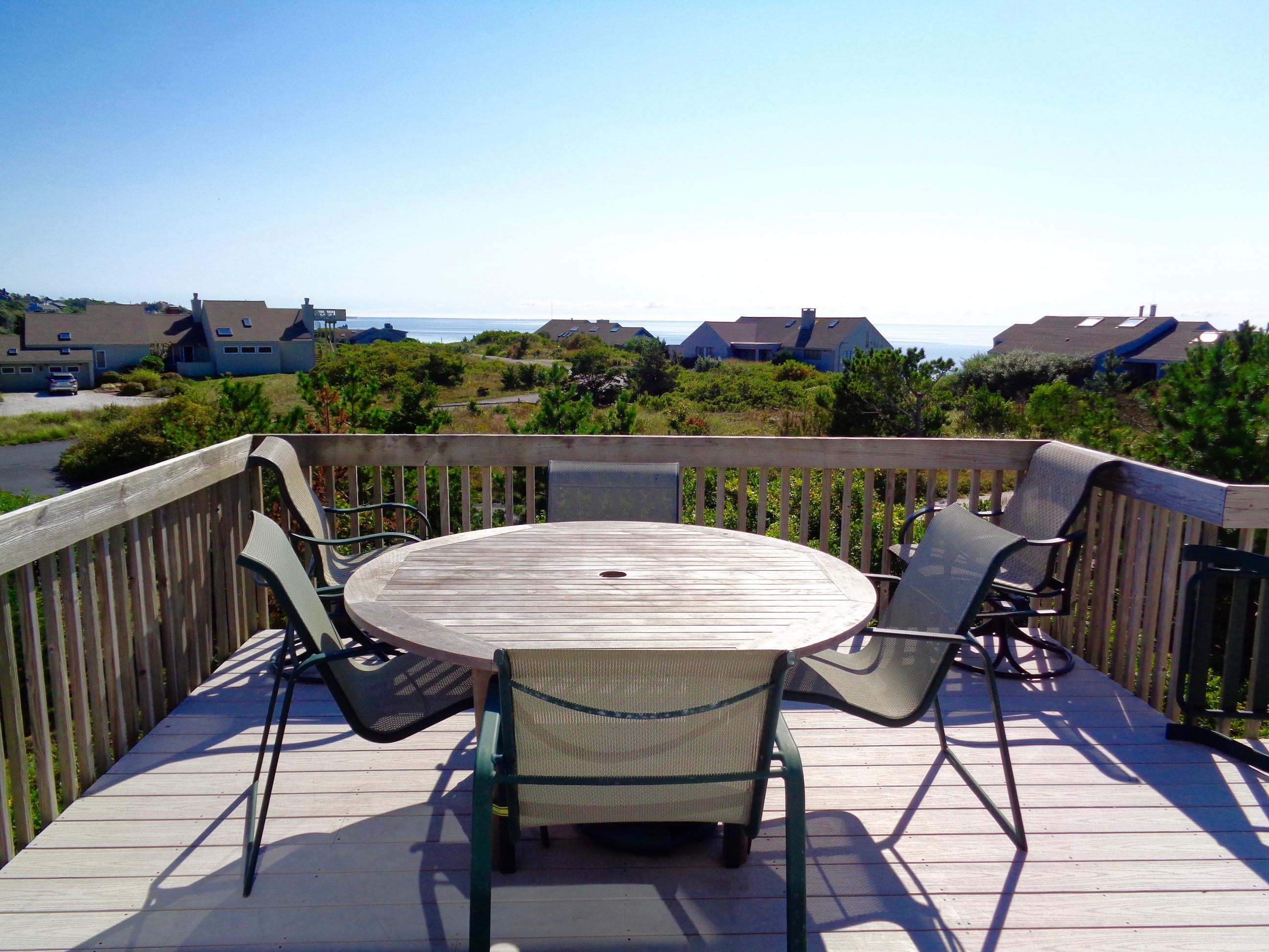 13 Avocet Road Truro, MA 02666 - Photo 7 of 35 a view of a chairs and table on the deck