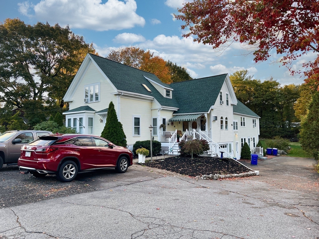 26 Wheeler Avenue, Unit 1 Rockland, MA 02370 - Photo 1 of 16 a front view of a house with a garden
