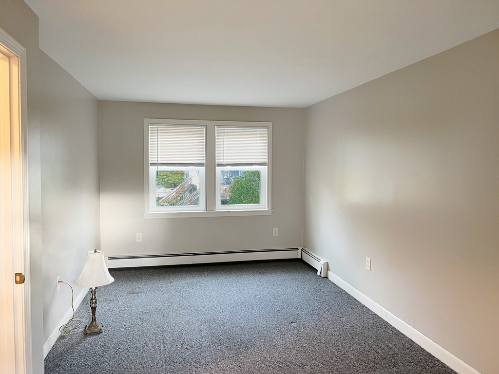26 Wheeler Avenue, Unit 1 Rockland, MA 02370 - Photo 7 of 16 an empty room with windows