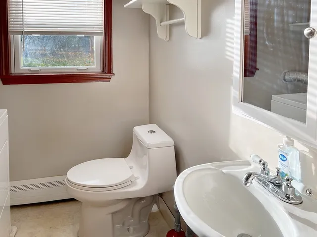 a white toilet sitting next to a bathroom sink