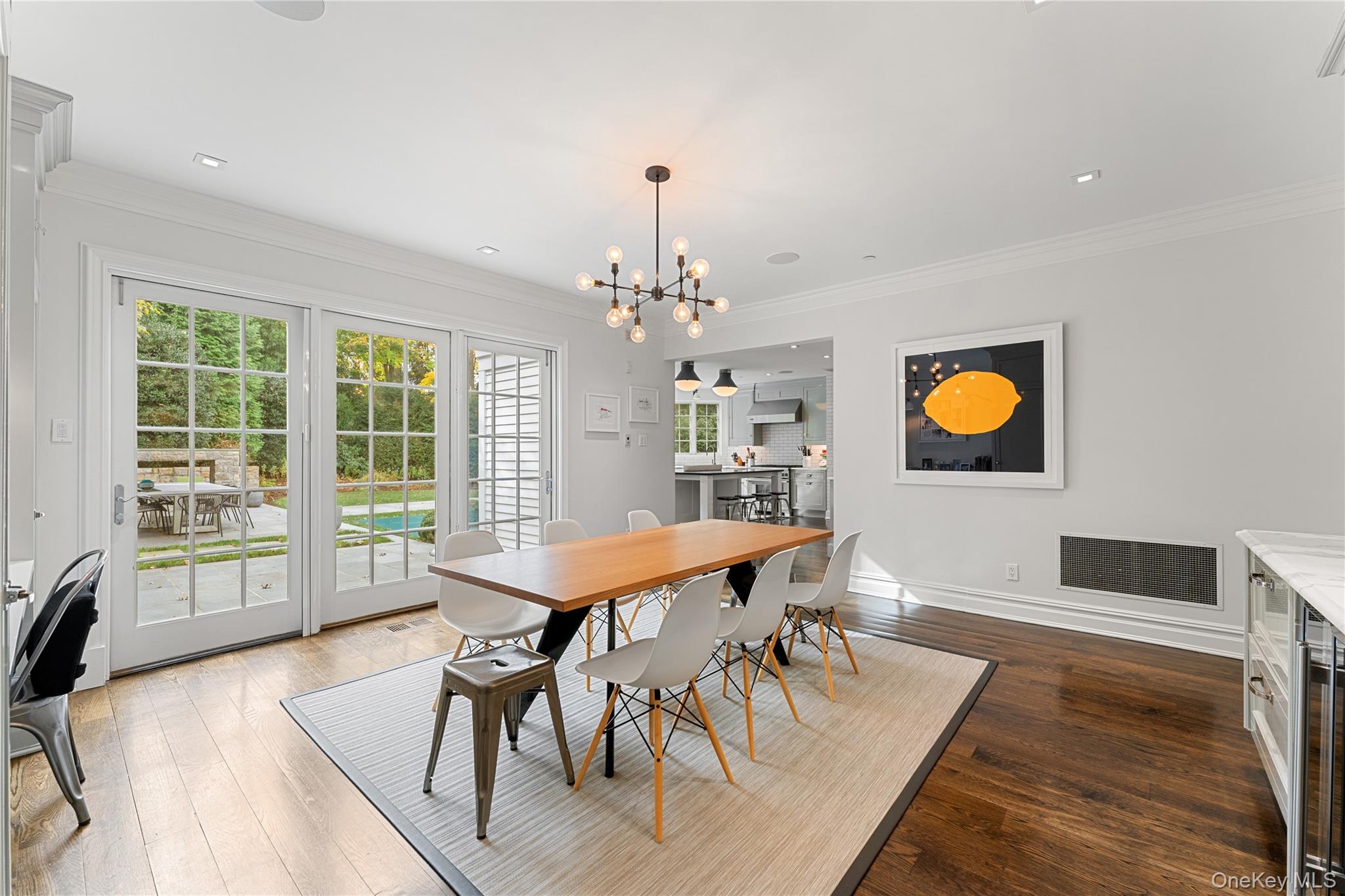 8 Richbell Road Scarsdale, NY 10583 - Photo 18 of 45 a dining room with wooden floor a chandelier a wooden table and chairs