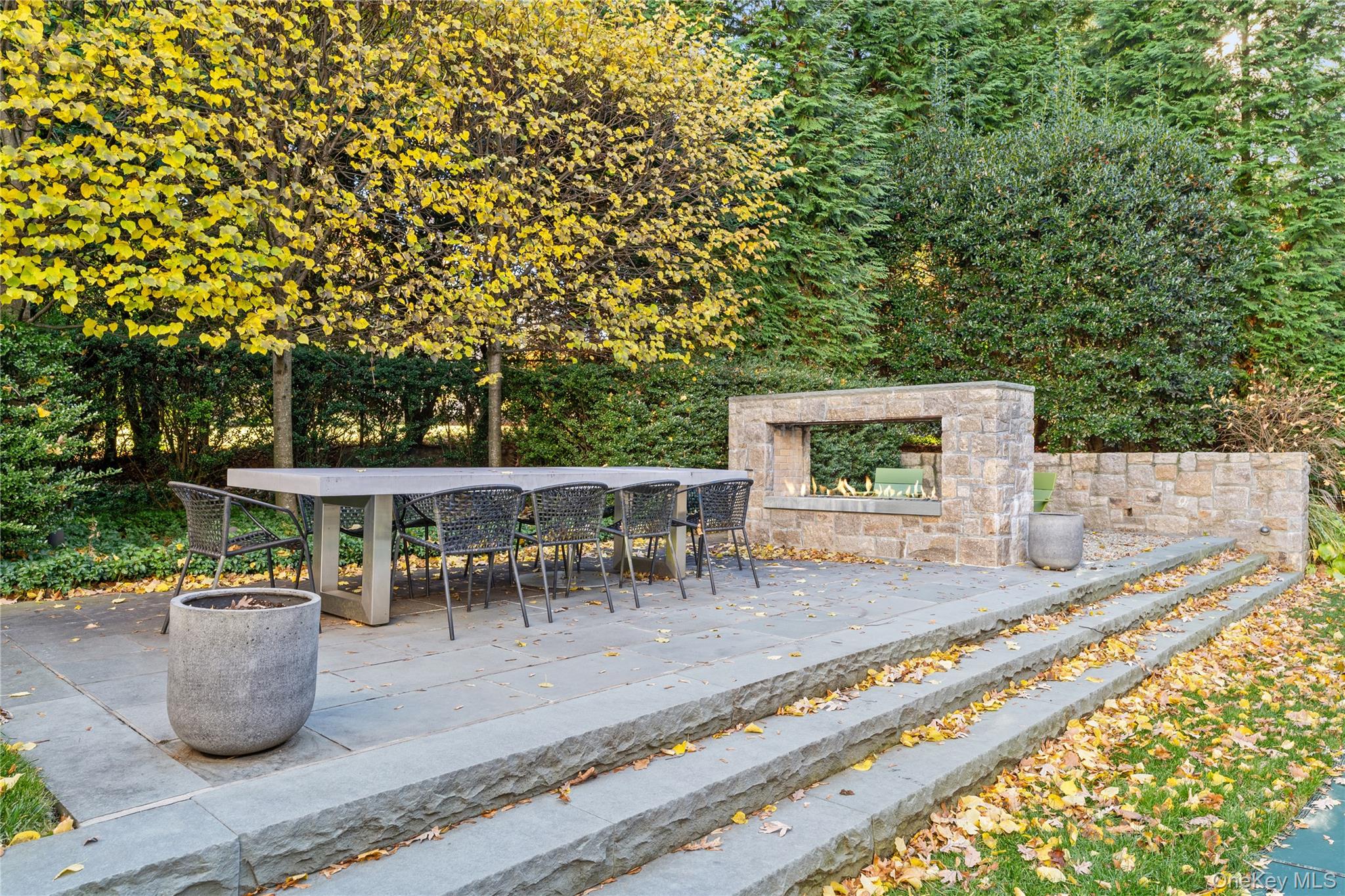 8 Richbell Road Scarsdale, NY 10583 - Photo 9 of 45 a view of a patio with table and chairs potted plants and large tree