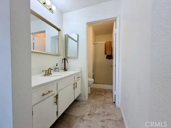 a spacious bathroom with a double vanity sink and a mirror