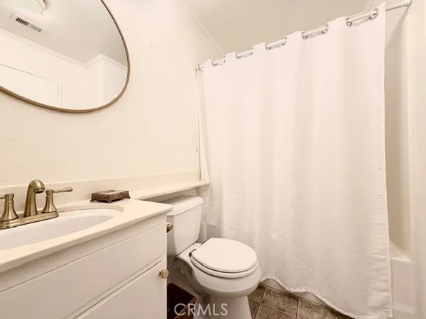a bathroom with a sink mirror and toilet