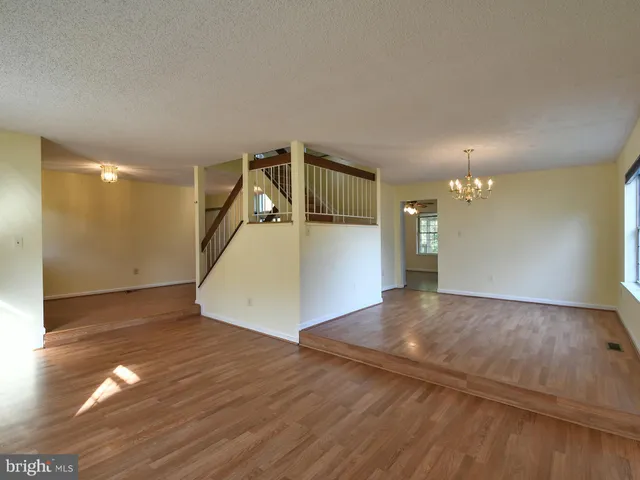 a living room with furniture a fireplace a flat screen tv and a large window
