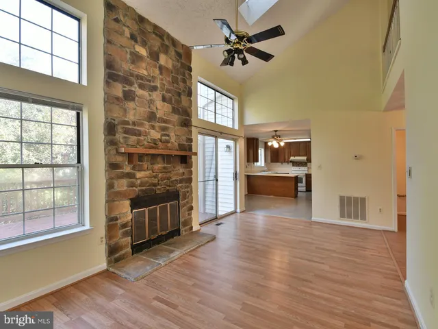 a kitchen with granite countertop a sink cabinets stainless steel appliances and a window