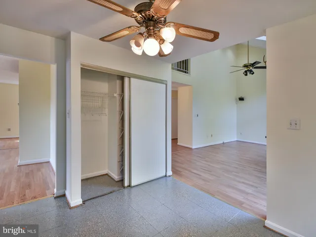 a view of staircase with wooden floor and white walls