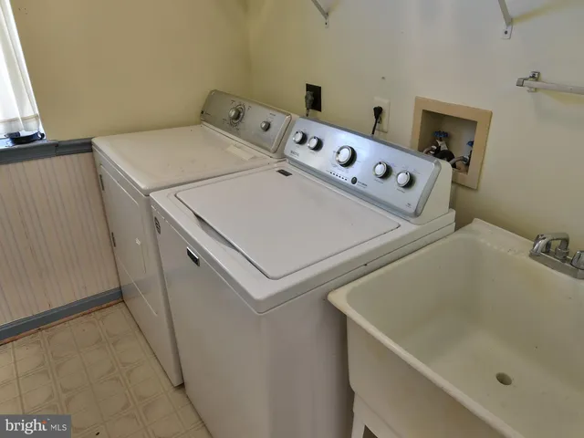 an empty room with wooden floor and window