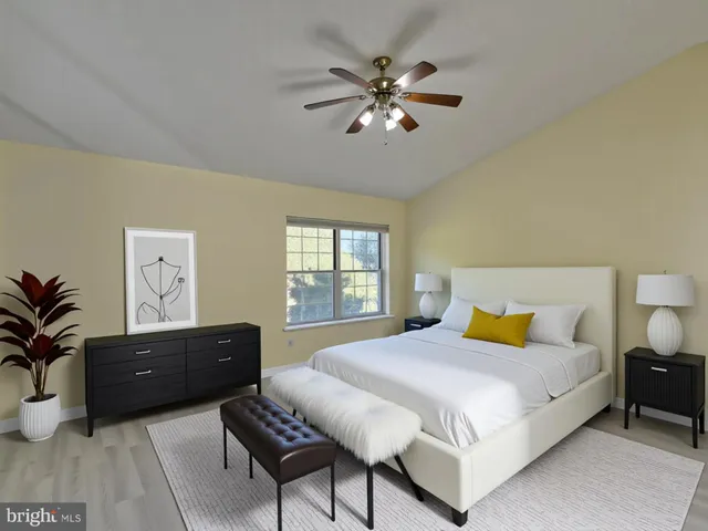 a view of a livingroom with workspace and a window