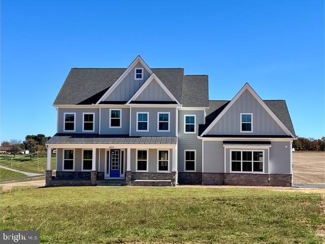 1261 New Design Road Tuscarora, MD 21790 - Photo 2 of 7 a front view of a house with a yard