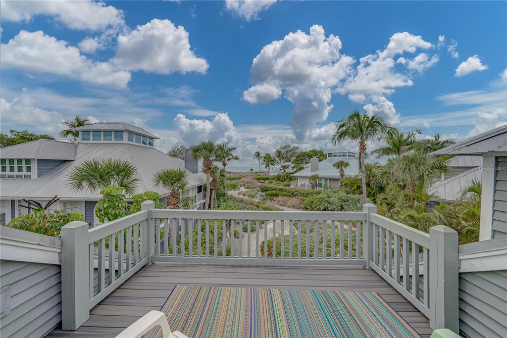 a view of a balcony with wooden floor