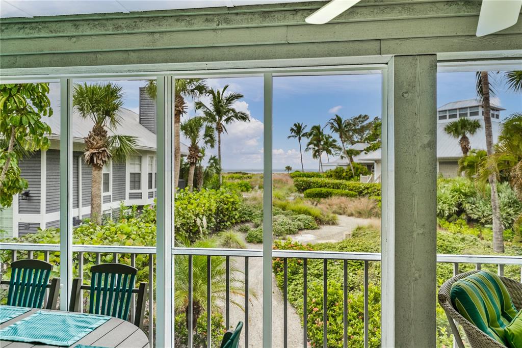 12 Seawatch Drive Boca Grande, FL 33921 - Photo 15 of 54 a view of a porch with a table and chairs