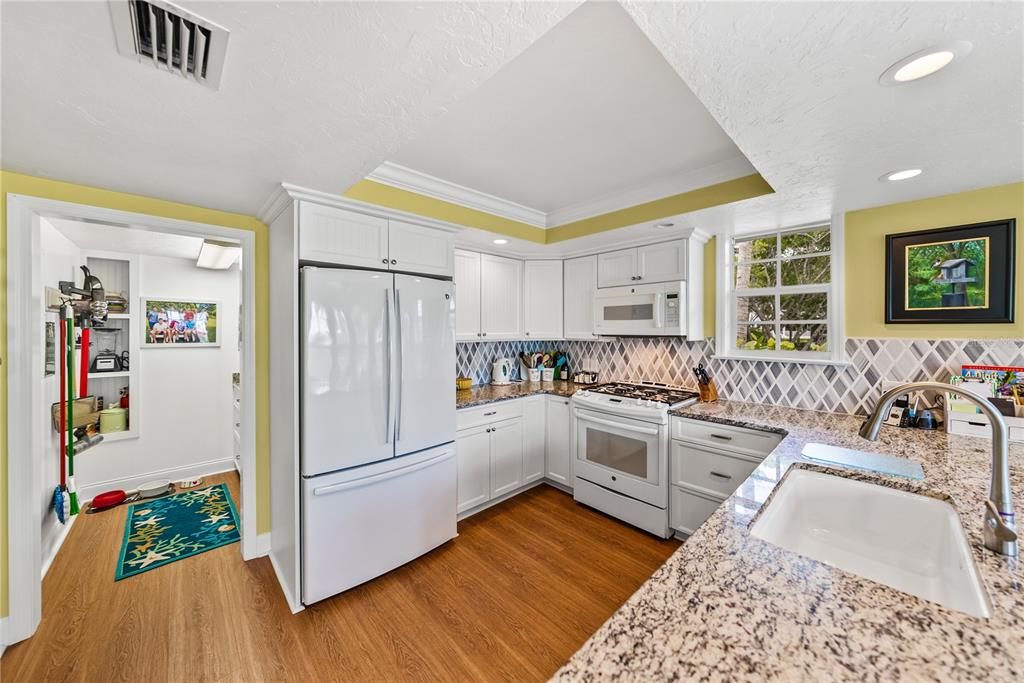 12 Seawatch Drive Boca Grande, FL 33921 - Photo 19 of 54 a kitchen with a refrigerator and a stove top oven