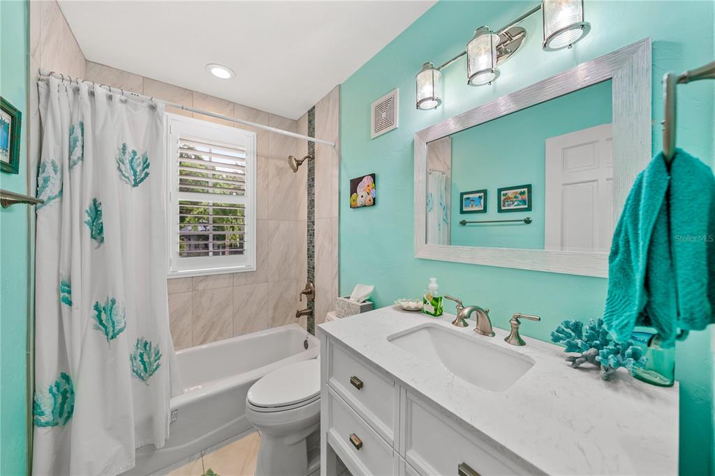 12 Seawatch Drive Boca Grande, FL 33921 - Photo 25 of 54 a bathroom with a sink a toilet a mirror a vanity and shower