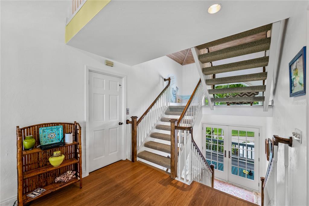 12 Seawatch Drive Boca Grande, FL 33921 - Photo 3 of 54 a view of a hallway with wooden floor and staircase