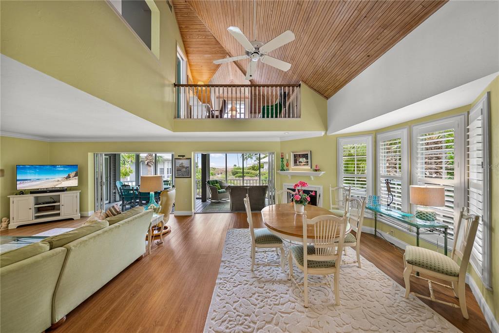12 Seawatch Drive Boca Grande, FL 33921 - Photo 4 of 54 a living room with furniture a fireplace and a large window
