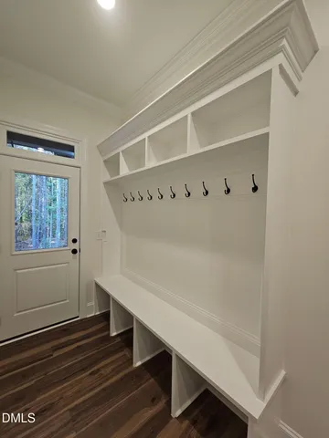 a view of a room with wooden floor and a window