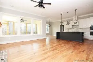 a large kitchen with cabinets and wooden floor