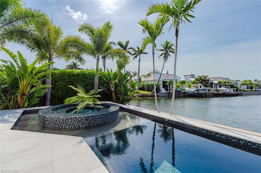 a house with swimming pool and chair