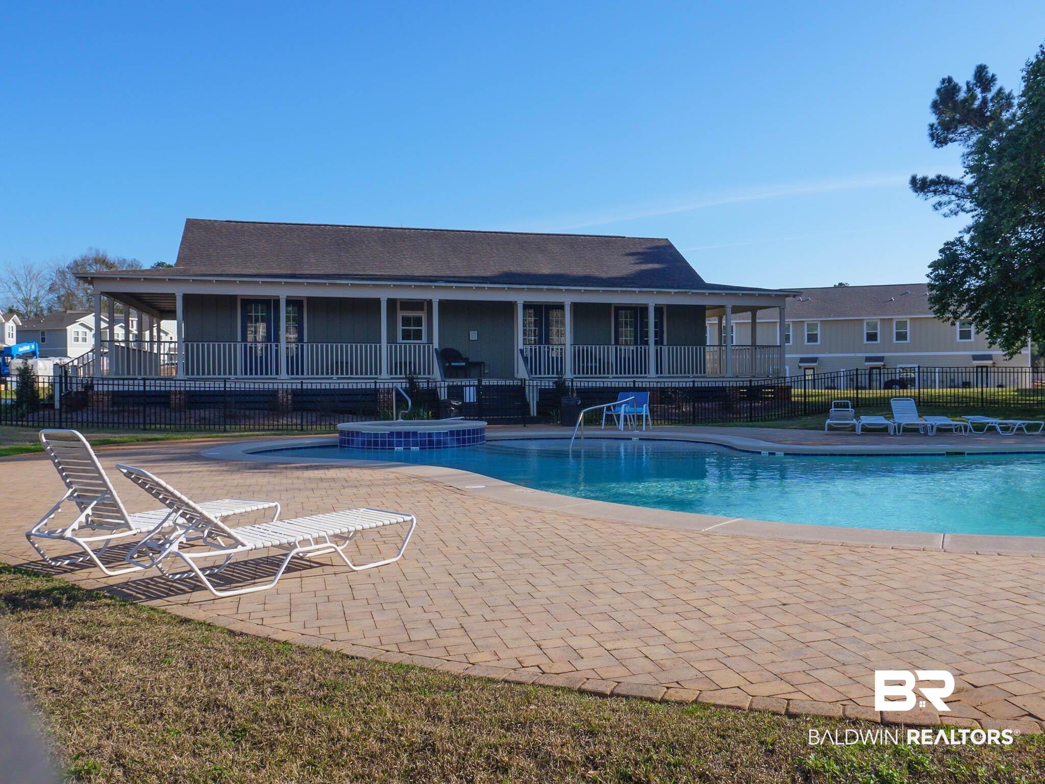 25806 Pollard Road, Unit 24 Daphne, AL 36526 - Photo 31 of 33 Community pool with a jacuzzi, a patio, and a large porch