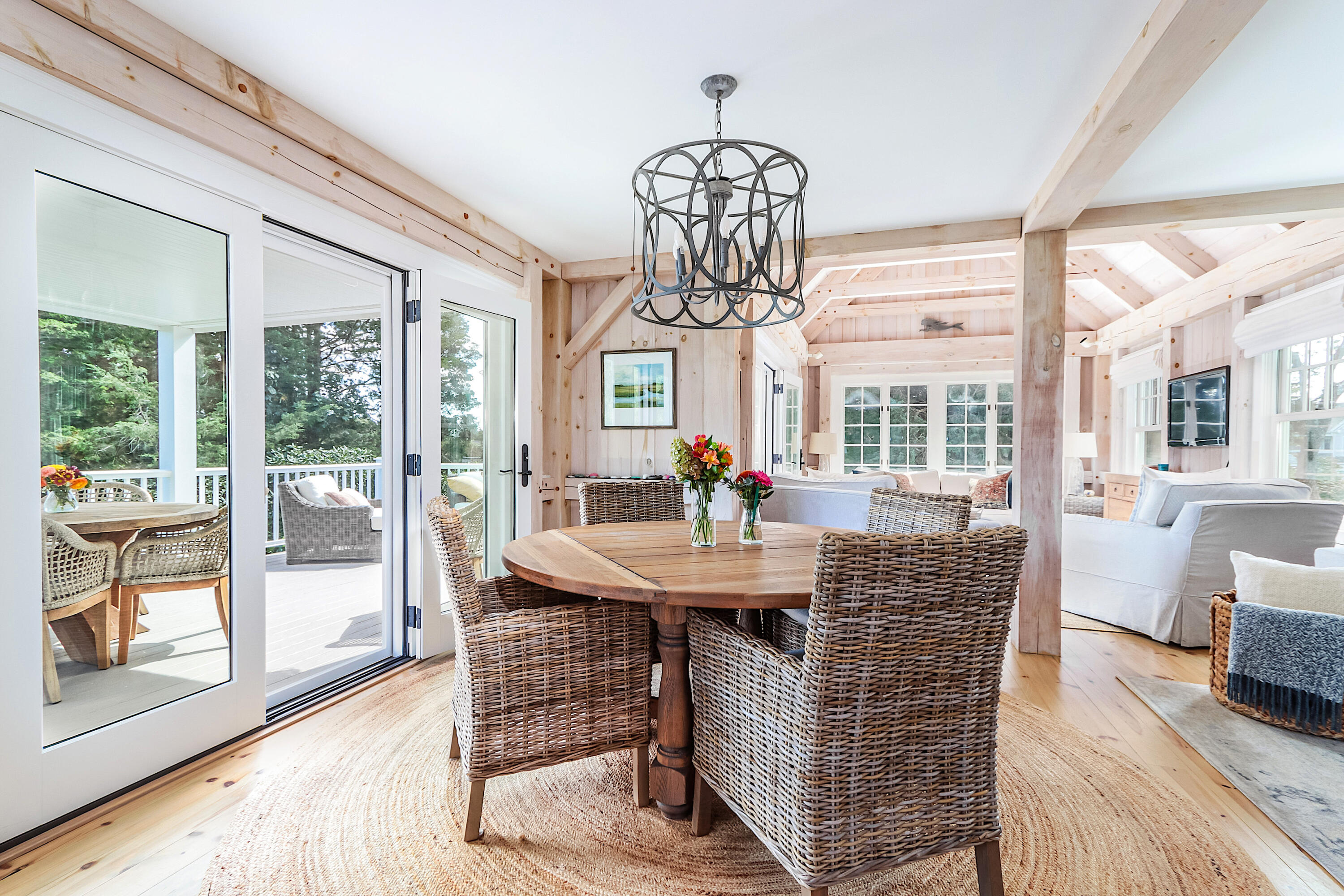 330 Sandy Neck Road West Barnstable, MA 02668 - Photo 11 of 45 a dining room with furniture a chandelier and wooden floor