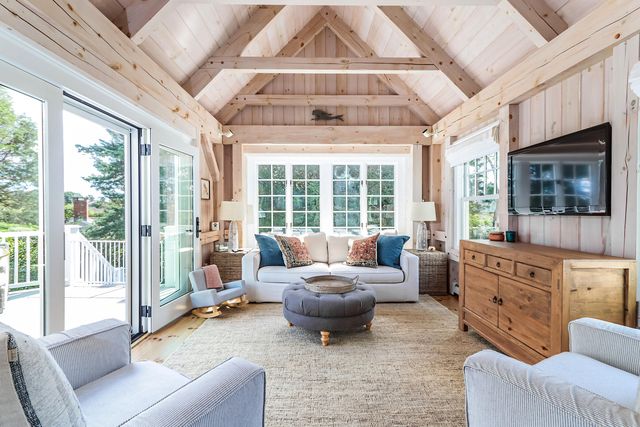 a living room with furniture large window and a fireplace
