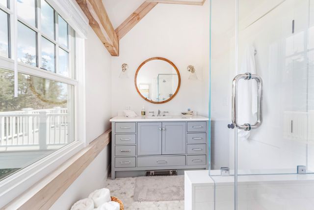 a spacious bedroom with a bed and wooden floor